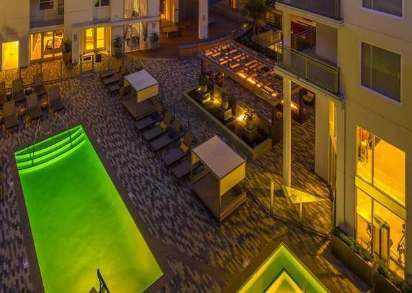 Resort-style pool with lounge chairs at The Desmond Apartments, luxury living in vibrant city setting