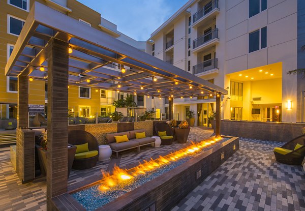 Outdoor recreational area with green spaces and seating at The Desmond Apartments
