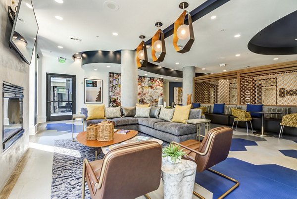 Modern clubhouse featuring elegant design and cozy seating at The Gallery at NoHo Commons Apartments