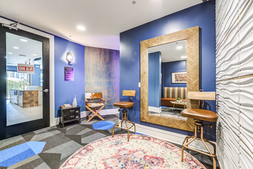 Bright and welcoming clubhouse interior at The Gallery at NoHo Commons Apartments, featuring modern decor and seating areas