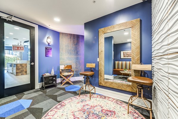 Bright and welcoming clubhouse interior at The Gallery at NoHo Commons Apartments, featuring modern decor and seating areas