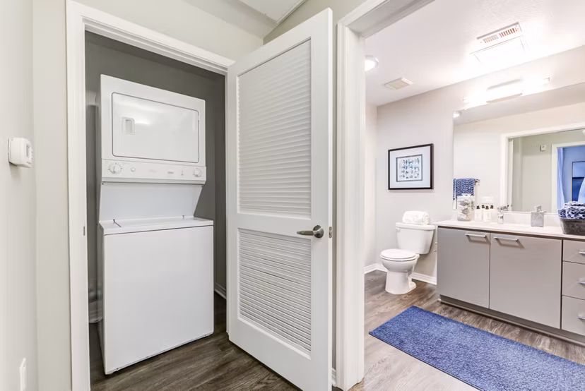 Laundry room equipped with modern appliances at The Gallery at NoHo Commons Apartments, convenient living in luxury apartments