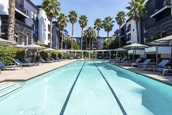 Outdoor pool area with lounge chairs at The Gallery at NoHo Commons Apartments, perfect for relaxation and enjoying the sun