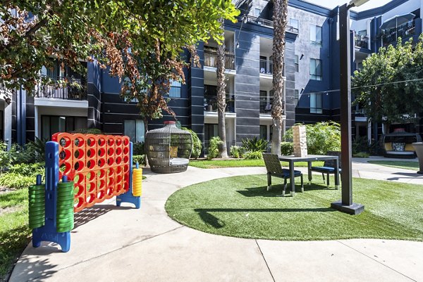 The Gallery at NoHo Commons: Tranquil courtyard with lush greenery and seating areas