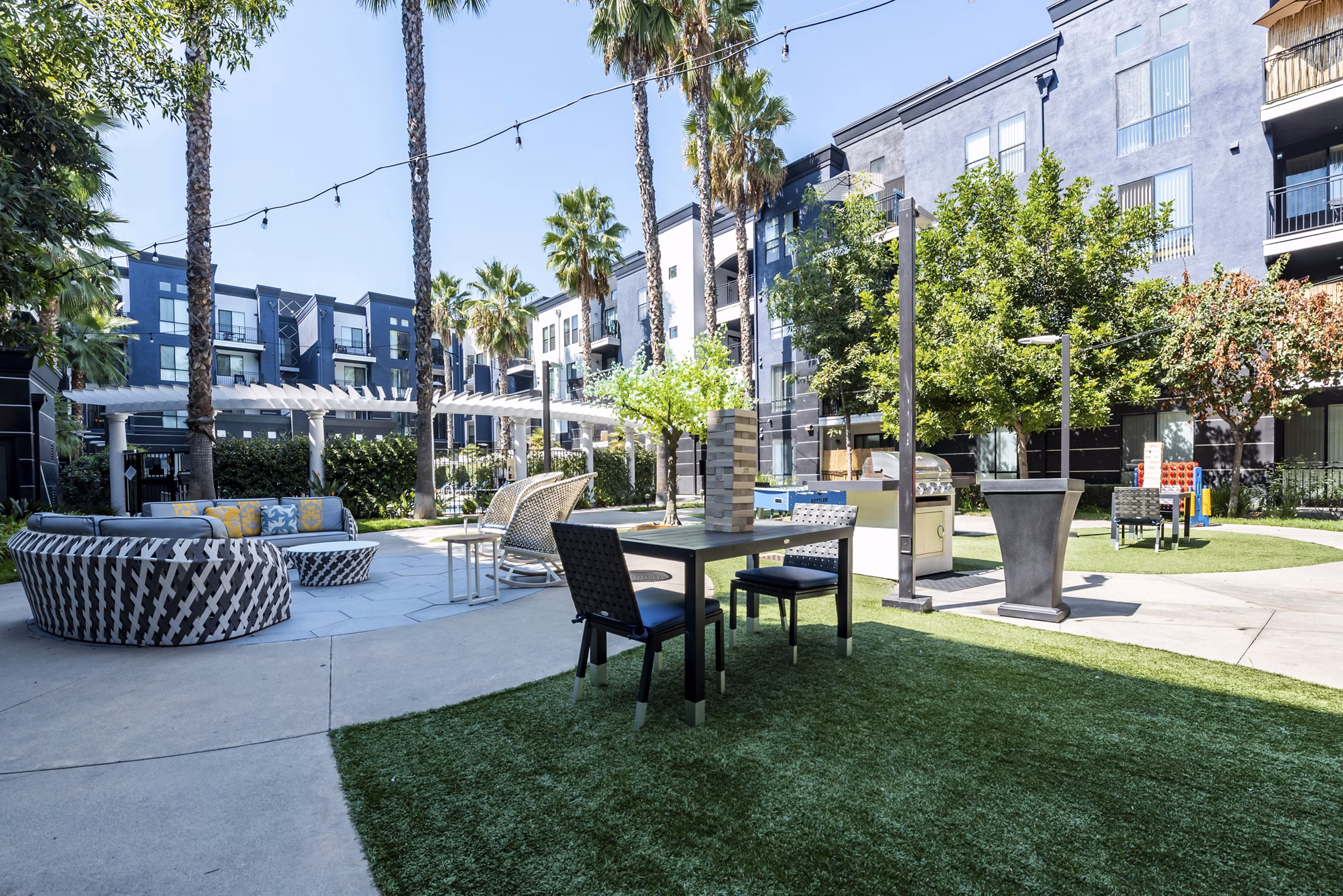 Courtyard with lush landscaping and seating at The Gallery at NoHo Commons luxury apartments