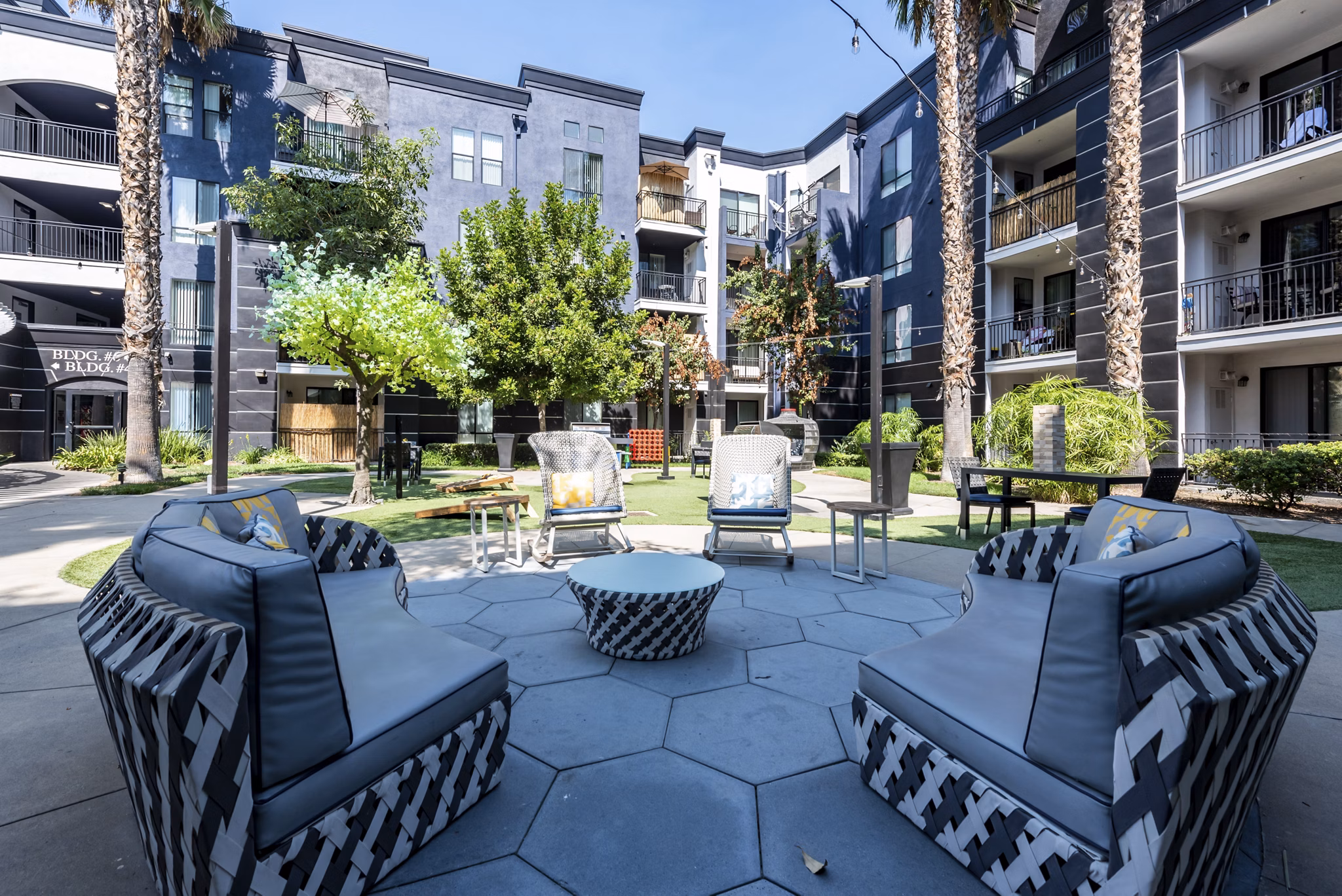 The Gallery at NoHo Commons: Tranquil courtyard with seating areas and lush greenery at luxury apartments in Los Angeles