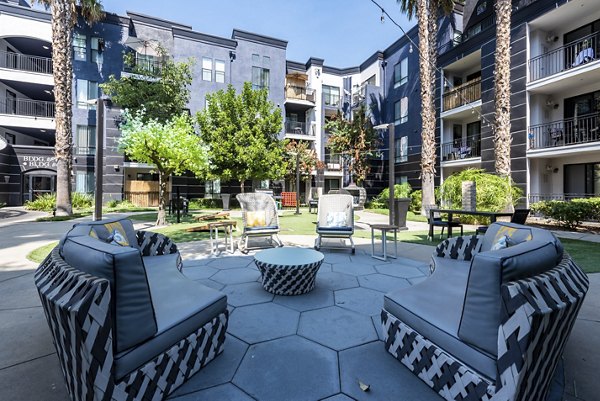 The Gallery at NoHo Commons: Tranquil courtyard with seating areas and lush greenery at luxury apartments in Los Angeles