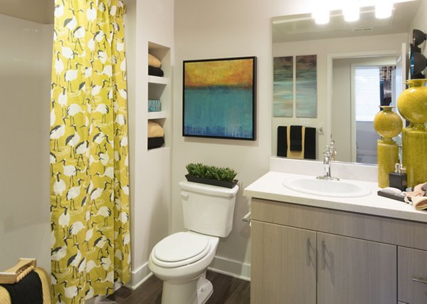 Modern bathroom featuring sleek fixtures and glass shower at The Verge Apartments