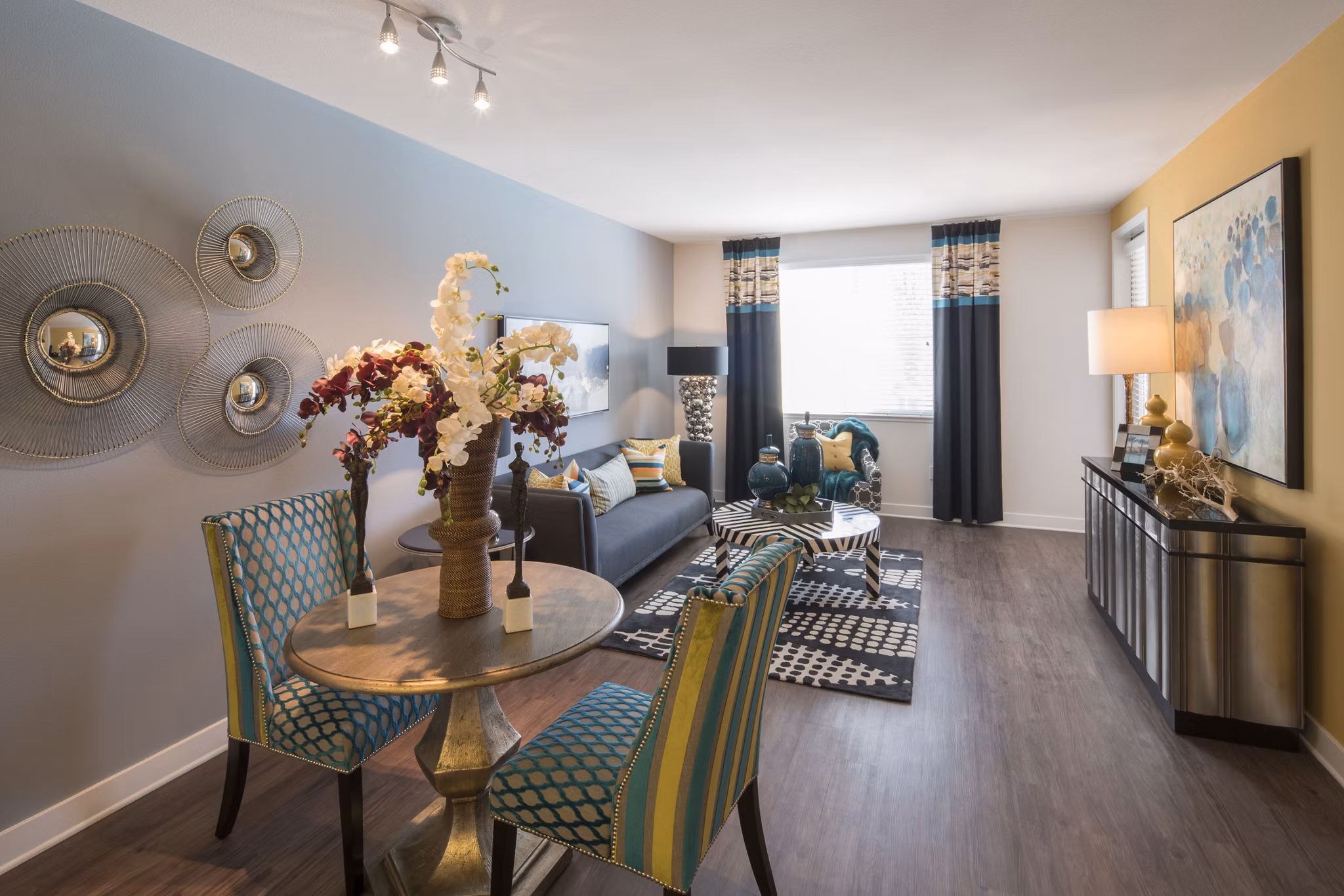 Dining room featuring a modern glass table and elegant chairs at The Verge Apartments in this stylish luxury living space