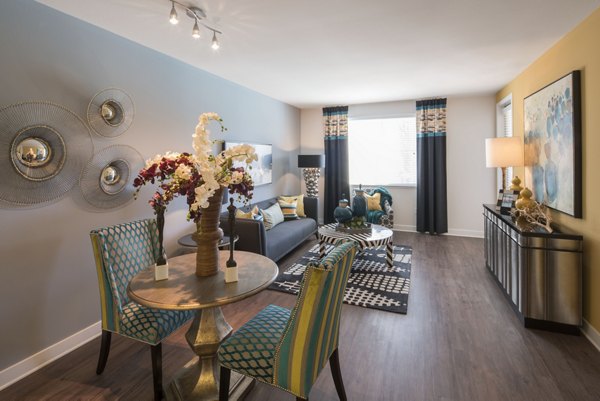 Dining room featuring a modern glass table and elegant chairs at The Verge Apartments in this stylish luxury living space