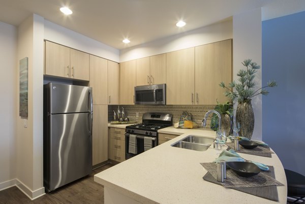 Modern kitchen with stainless steel appliances at The Verge Apartments