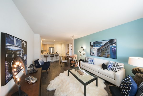 Spacious living room with modern decor at The Verge Apartments, showcasing luxury urban living