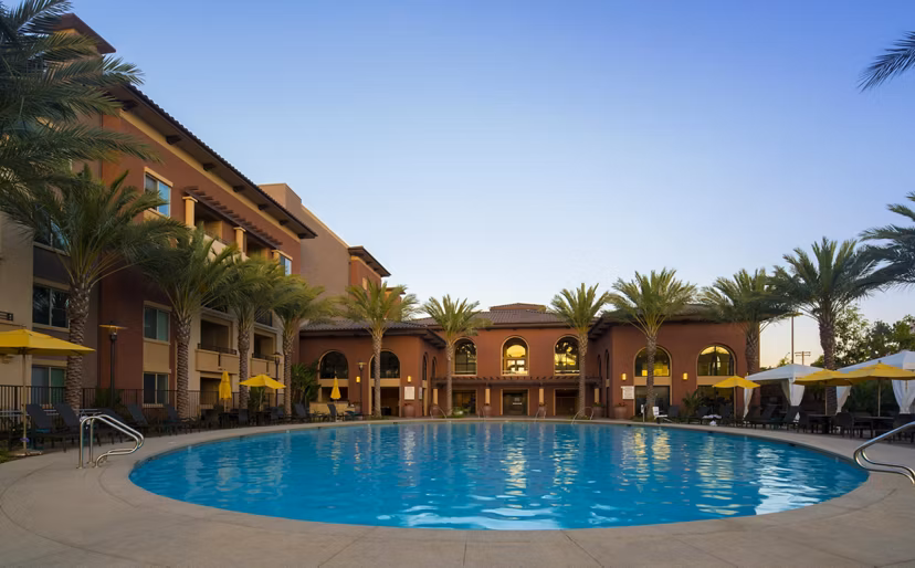 Luxurious outdoor pool with lounge chairs at The Verge Apartments