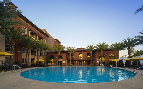 Luxurious outdoor pool with lounge chairs at The Verge Apartments