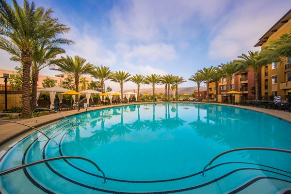 Resort-style pool with cabanas at The Verge Apartments, ideal for relaxation and leisure activities