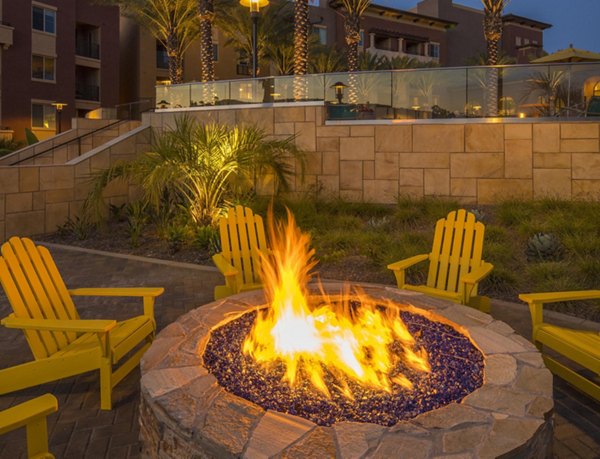 Cozy outdoor fire pit area with seating at The Verge Apartments, perfect for relaxation and socializing in a luxury setting