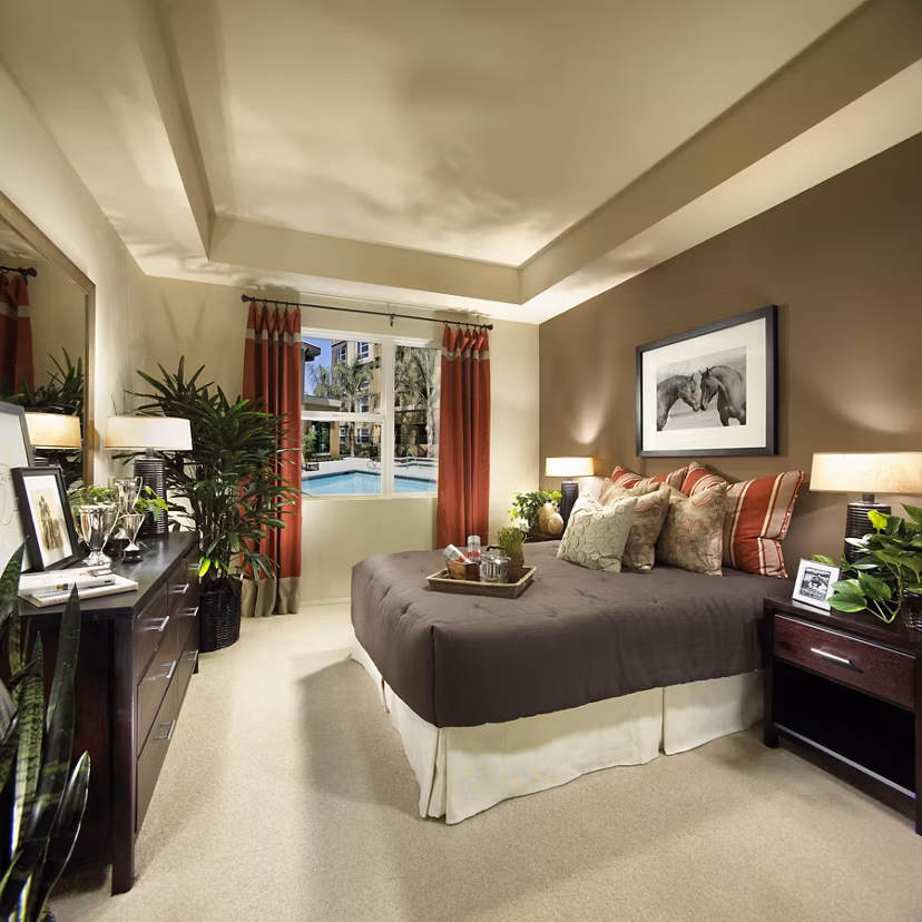 Cozy bedroom with ample natural light at Calypso Apartments and Lofts
