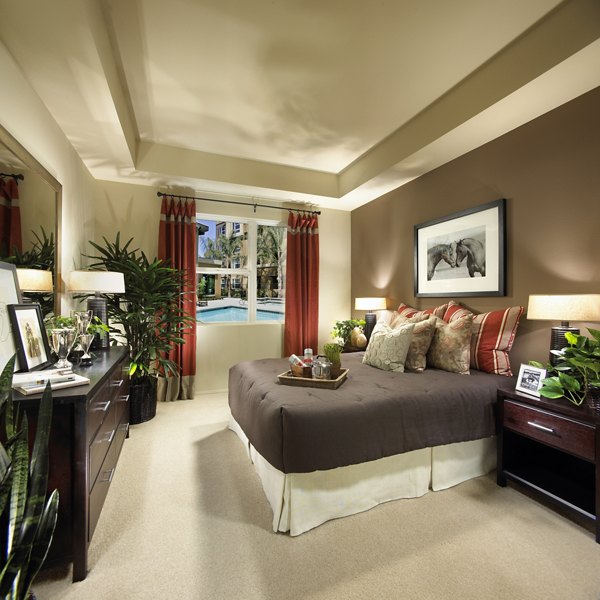 Cozy bedroom with ample natural light at Calypso Apartments and Lofts