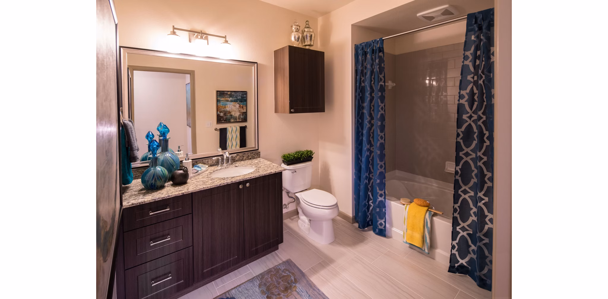 Modern bathroom with sleek fixtures at Blue Sol Apartments, featuring luxury finishes and large mirrors