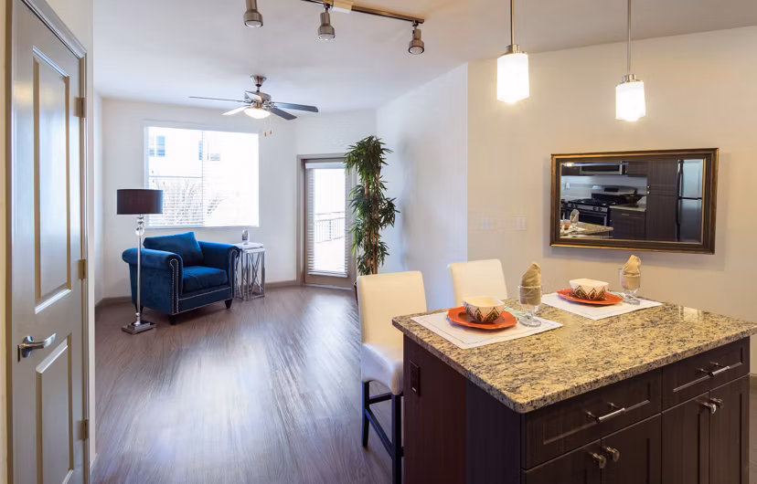 Modern kitchen with stainless steel appliances and granite countertops at Blue Sol Apartments
