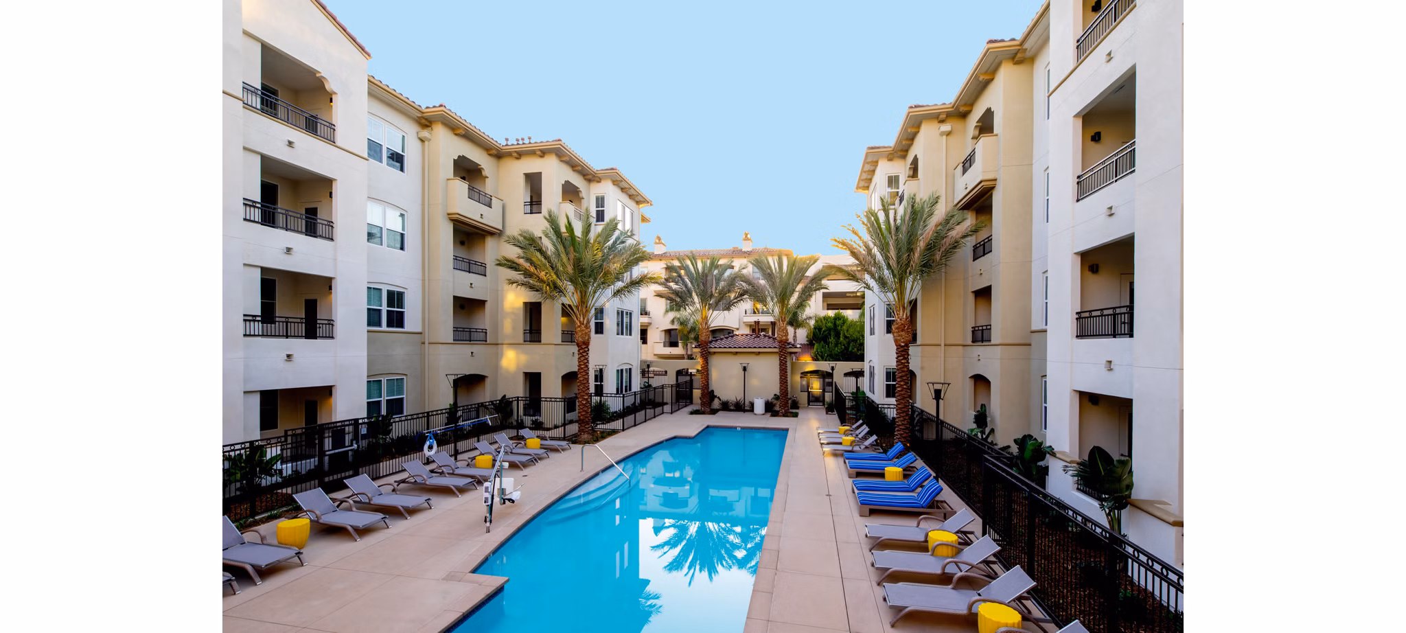 Resort-style pool with sun loungers at Blue Sol Apartments, a luxury Greystar property