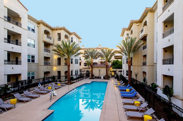 Resort-style pool with sun loungers at Blue Sol Apartments, a luxury Greystar property