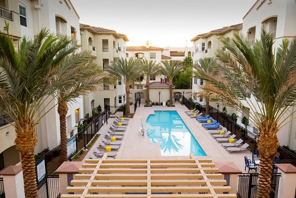 Relaxing outdoor pool with lounge chairs at Blue Sol Apartments, luxury living in Greystar's exclusive community