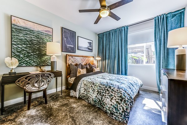 Cozy bedroom with modern decor at Luce Apartments, a luxury Greystar community