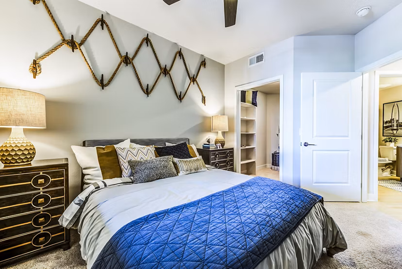 Cozy bedroom with modern decor at Luce Apartments in luxury Greystar community