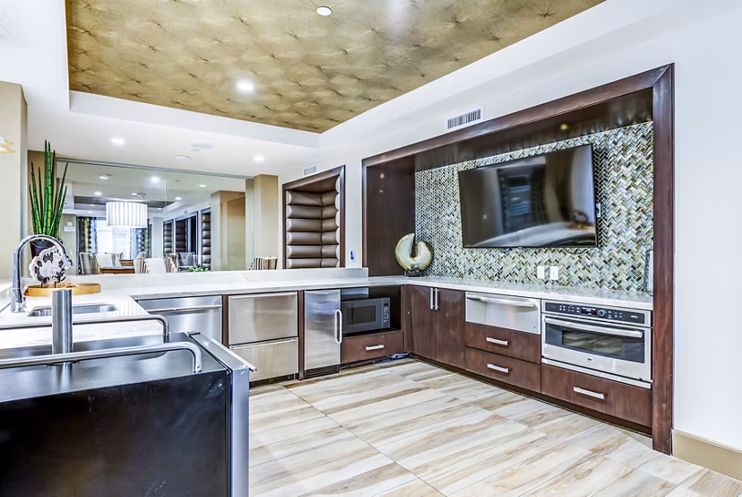 Contemporary clubhouse with stylish bar and modern kitchen at Luce Apartments