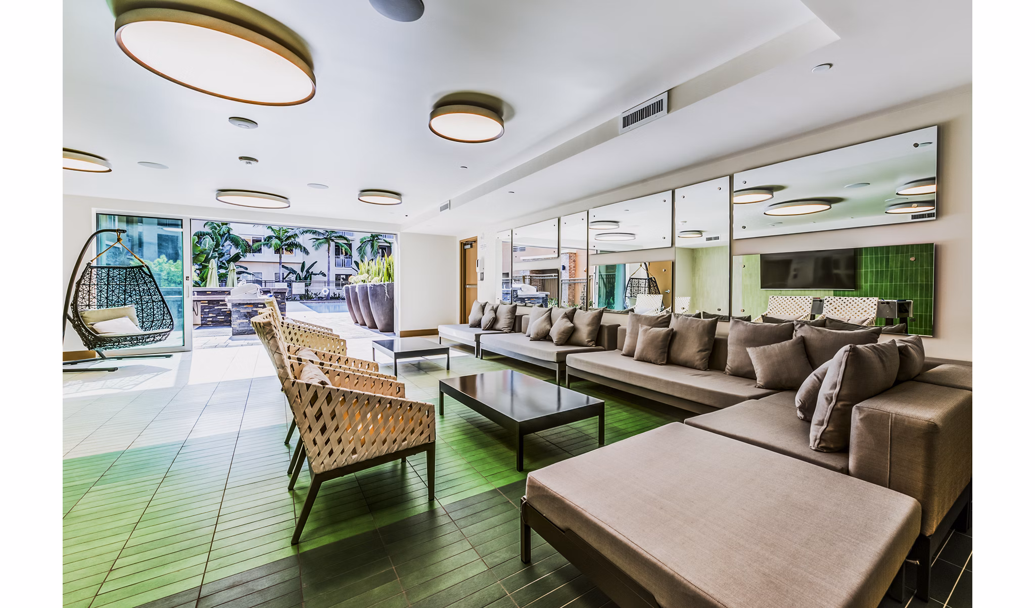 Luce Apartments: Modern patio and vibrant game room offering entertainment in a luxurious setting