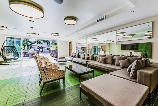 Luce Apartments: Modern patio and vibrant game room offering entertainment in a luxurious setting