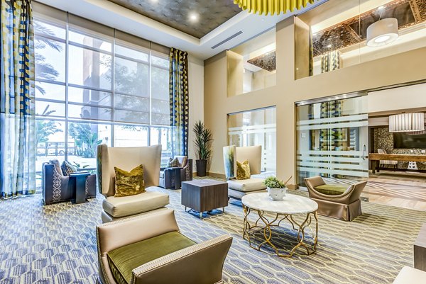 Luce Apartments: Stylish clubhouse lobby featuring modern seating and art displays in a luxury apartment community