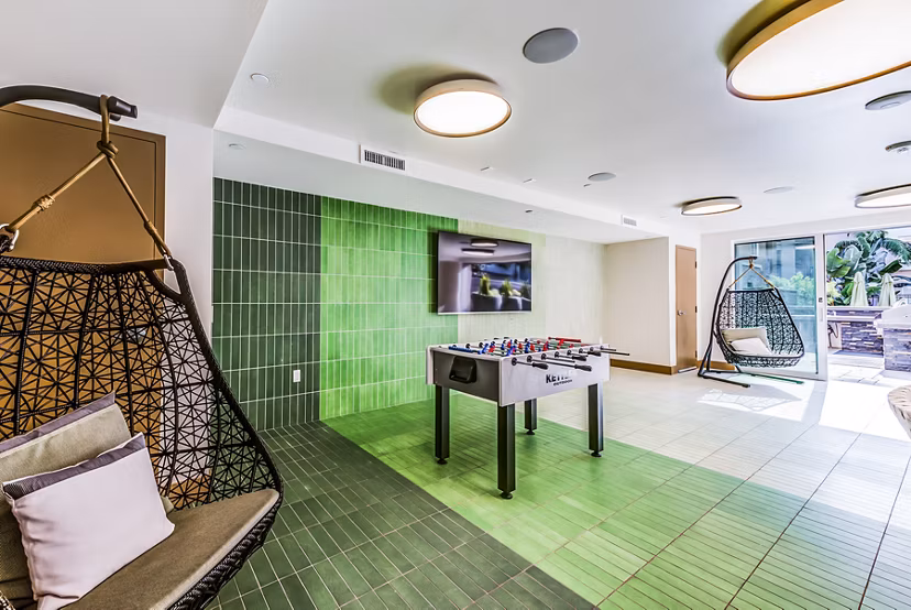 Modern game room with a spacious patio at Luce Apartments