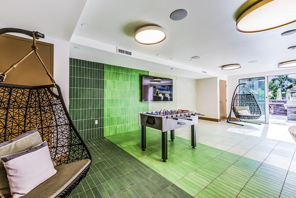 Modern game room with a spacious patio at Luce Apartments