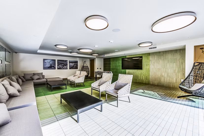 Luce Apartments: Patio and game room with stylish seating and entertainment options