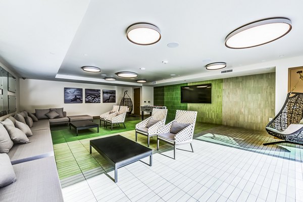 Luce Apartments: Patio and game room with stylish seating and entertainment options