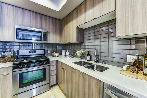 Modern kitchen featuring stainless steel appliances at Luce Apartments