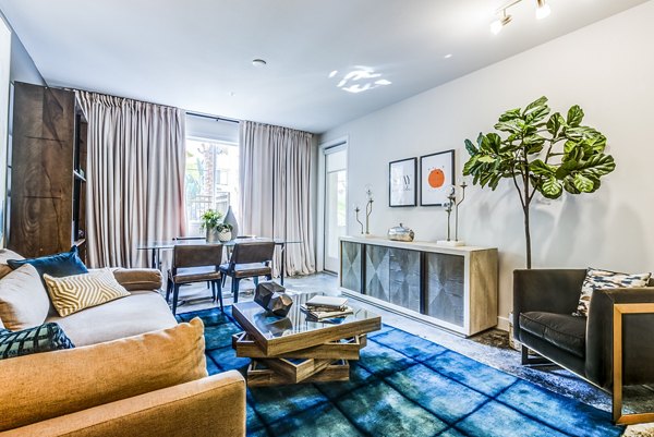Modern living room with chic furniture and large windows at Luce Apartments