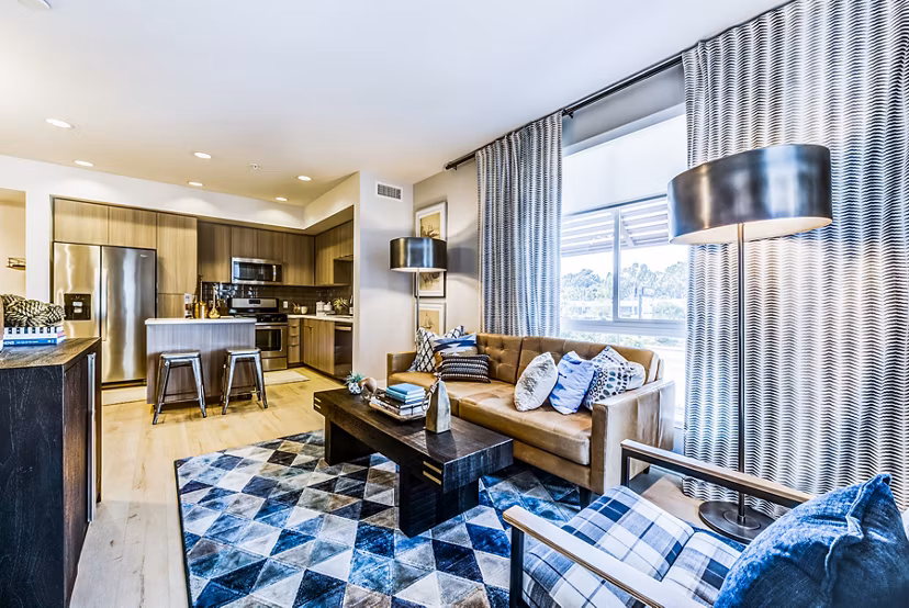 Modern living room with sleek furnishings and large windows at Luce Apartments, offering luxury living in a stylish setting