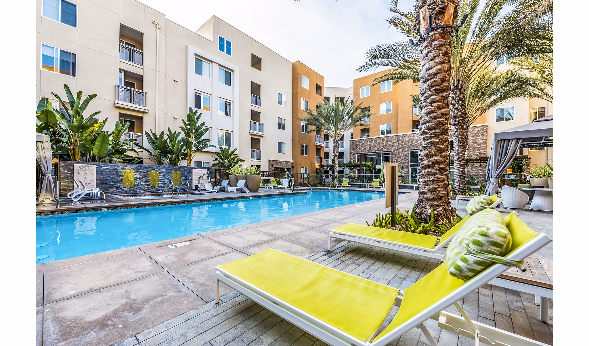 Rooftop pool with lounge chairs at Luce Apartments, a luxury community by Greystar