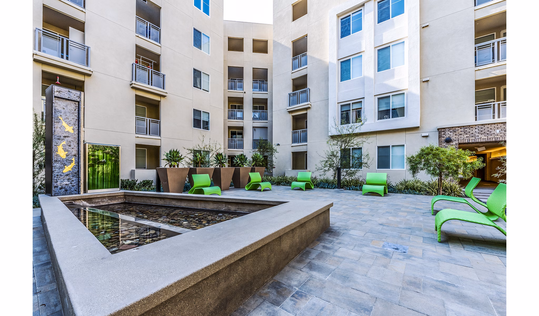 Lush courtyard with comfortable seating and greenery at Luce Apartments