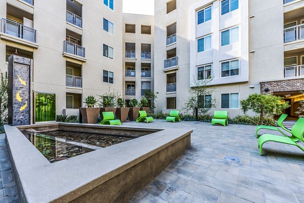 Lush courtyard with comfortable seating and greenery at Luce Apartments