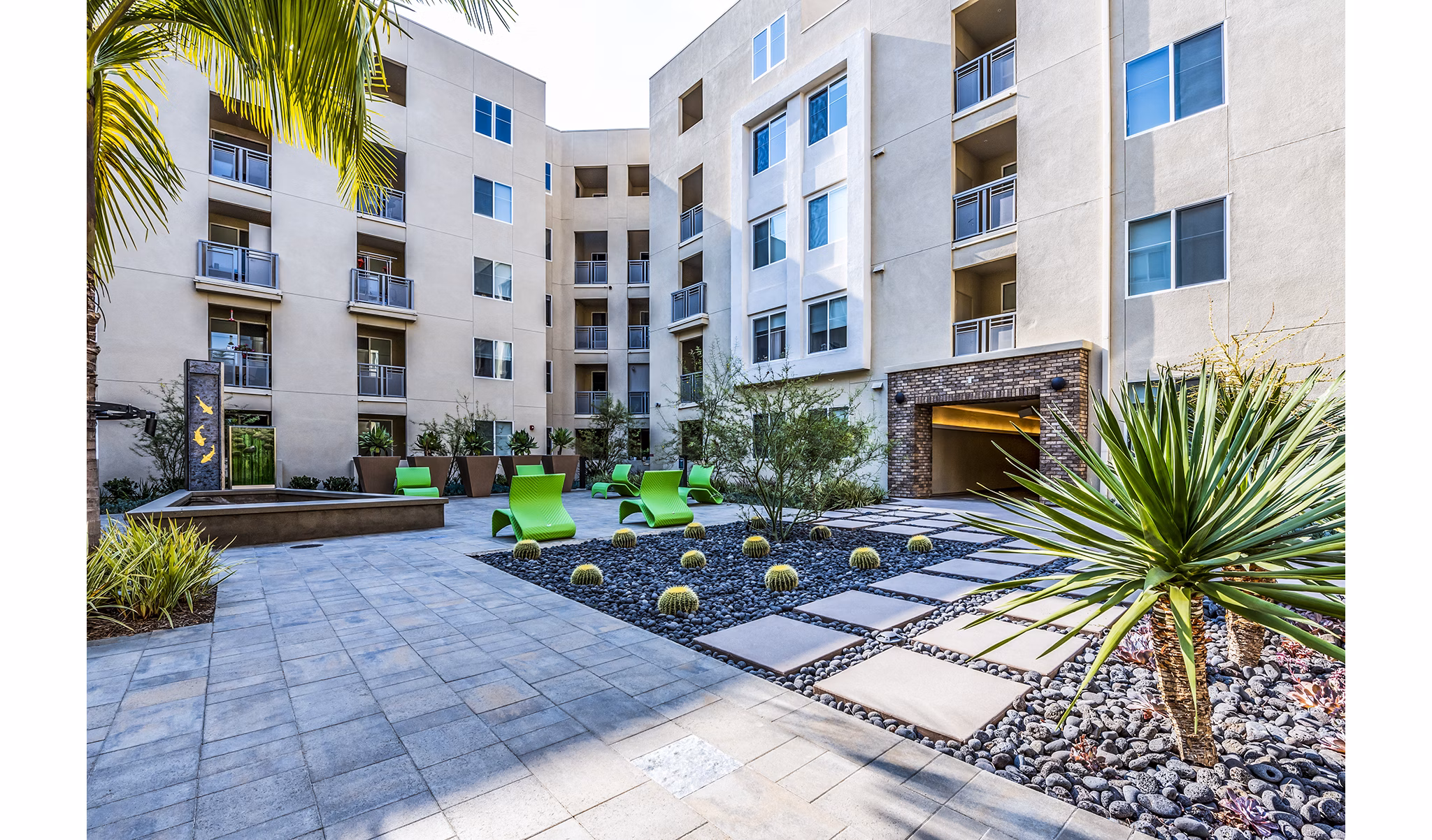 Luce Apartments: Serene courtyard with lush gardens and seating areas in luxury community