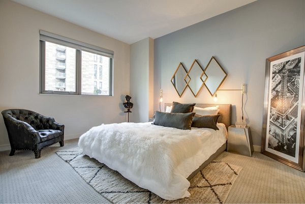 Cozy bedroom with modern furnishings at Argenta Apartments, featuring plush bedding and stylish decor