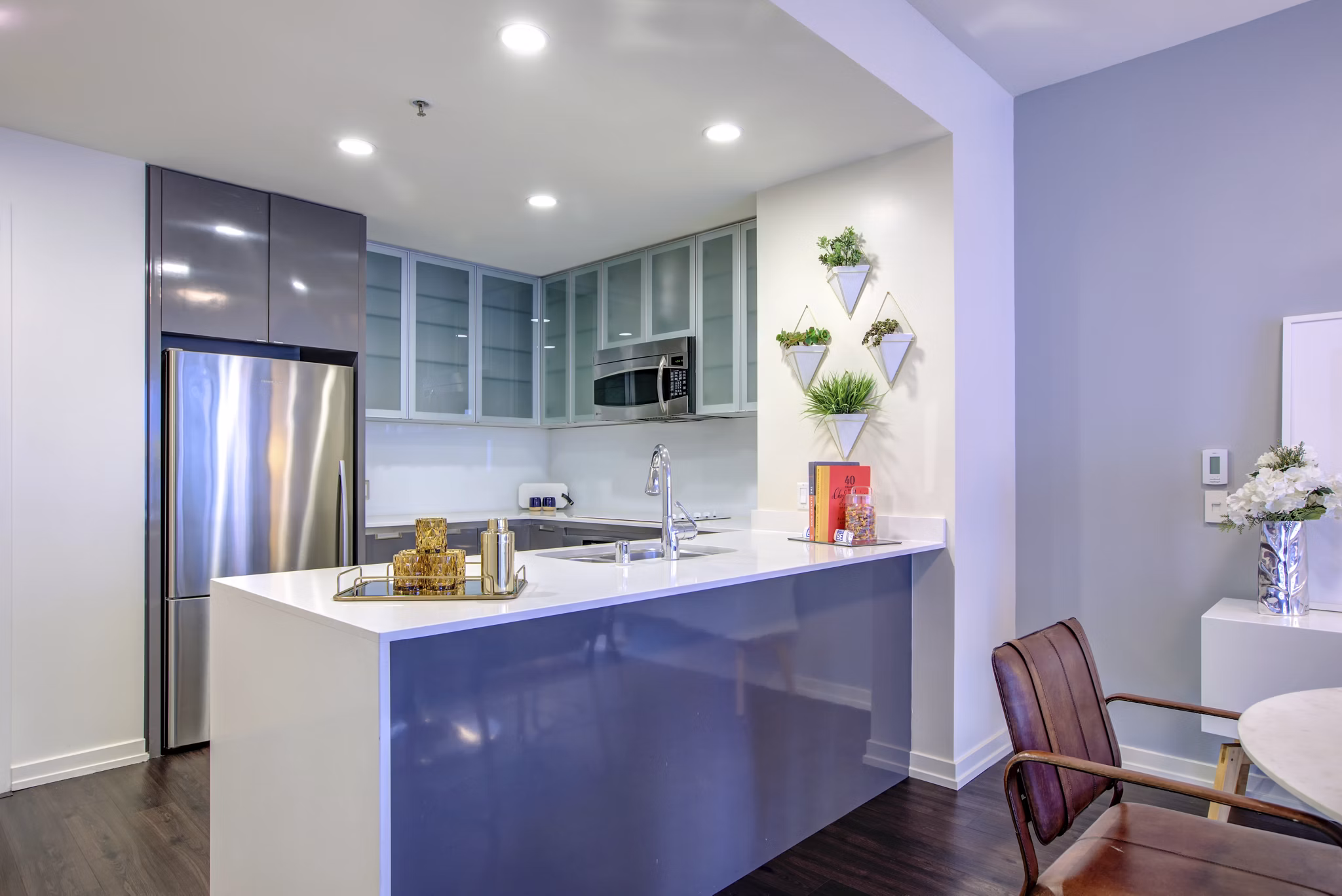 Contemporary kitchen with sleek cabinetry and stainless steel appliances in Argenta Apartments, a luxury  community