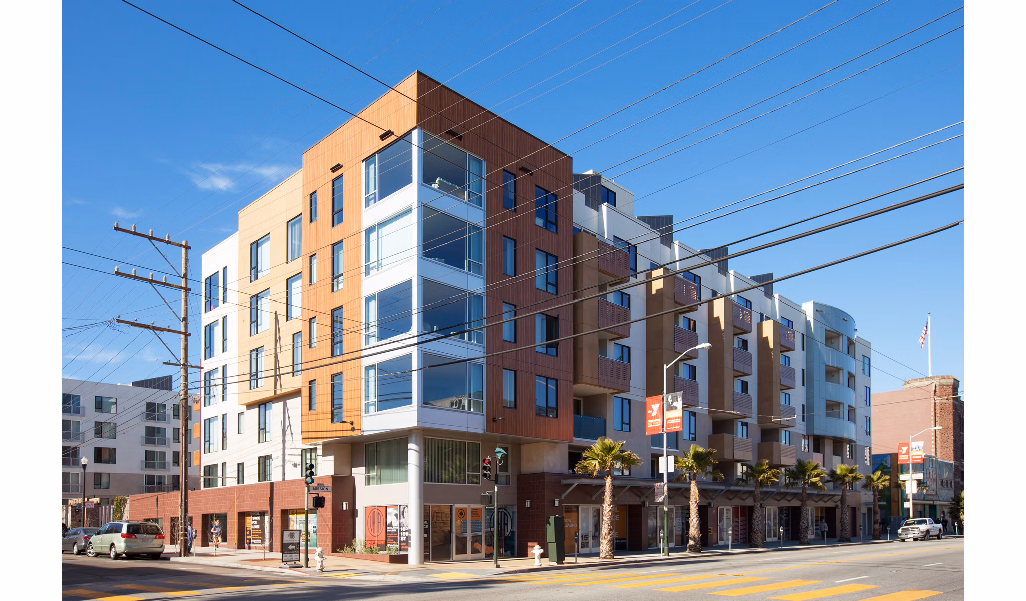 Modern multi-story luxury apartments on a street corner in an urban location