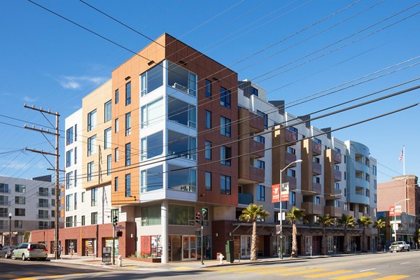 Modern multi-story luxury apartments on a street corner in an urban location