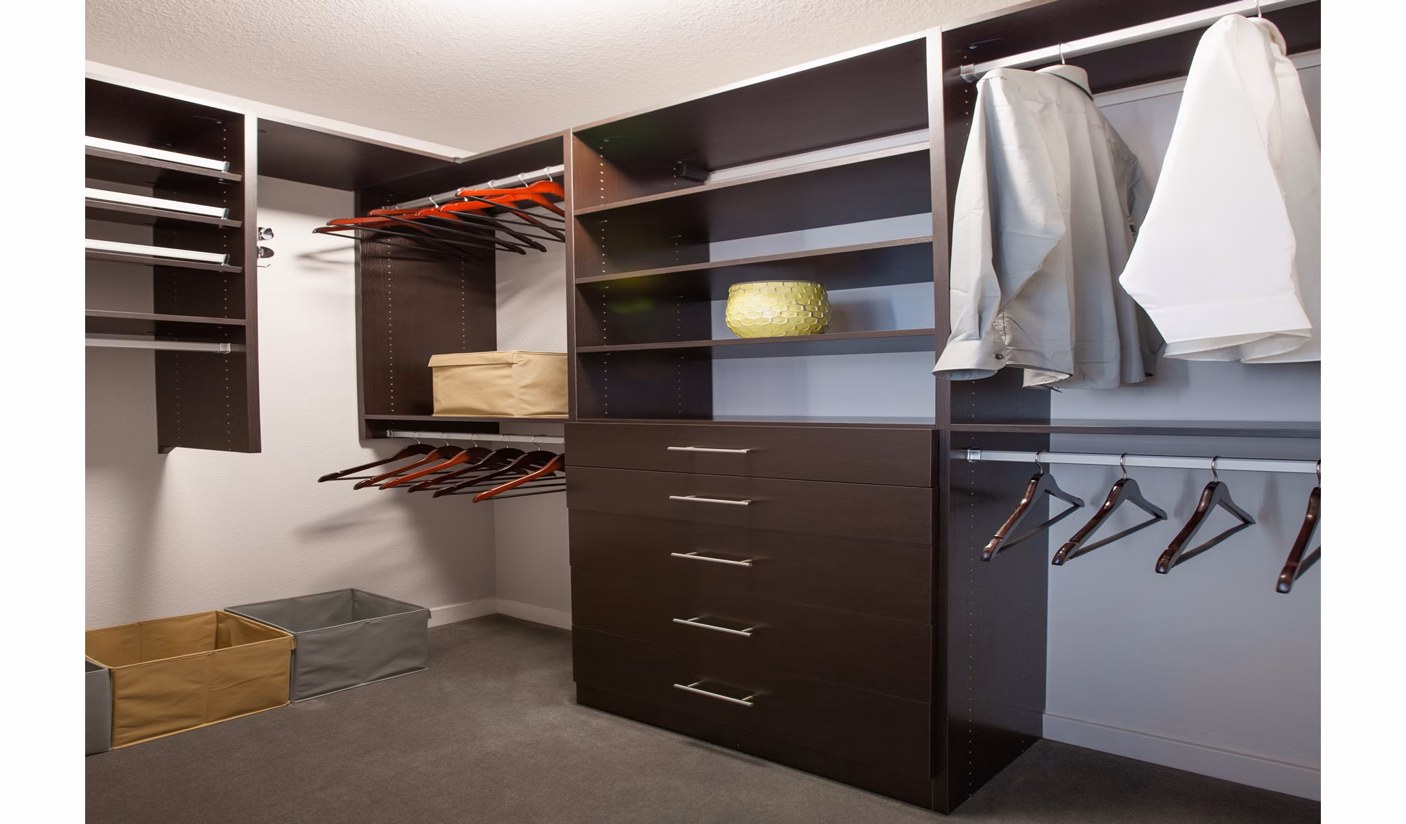 Walk-in closet featuring shelves, drawers, and storage bins in luxury apartments