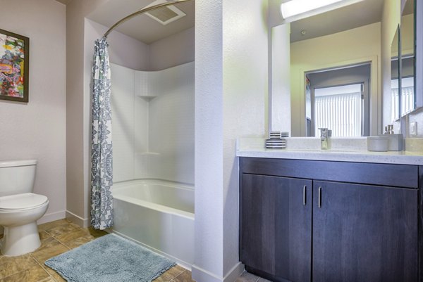 Modern bathroom with glass shower and sleek fixtures at Vara Apartments